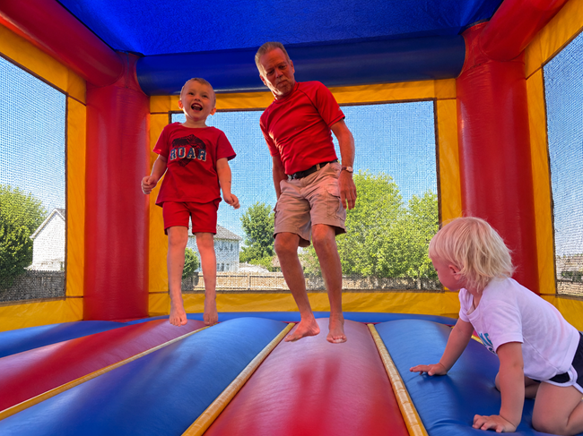 Kids bouncing inside a Backyard Party Rentals bounce house