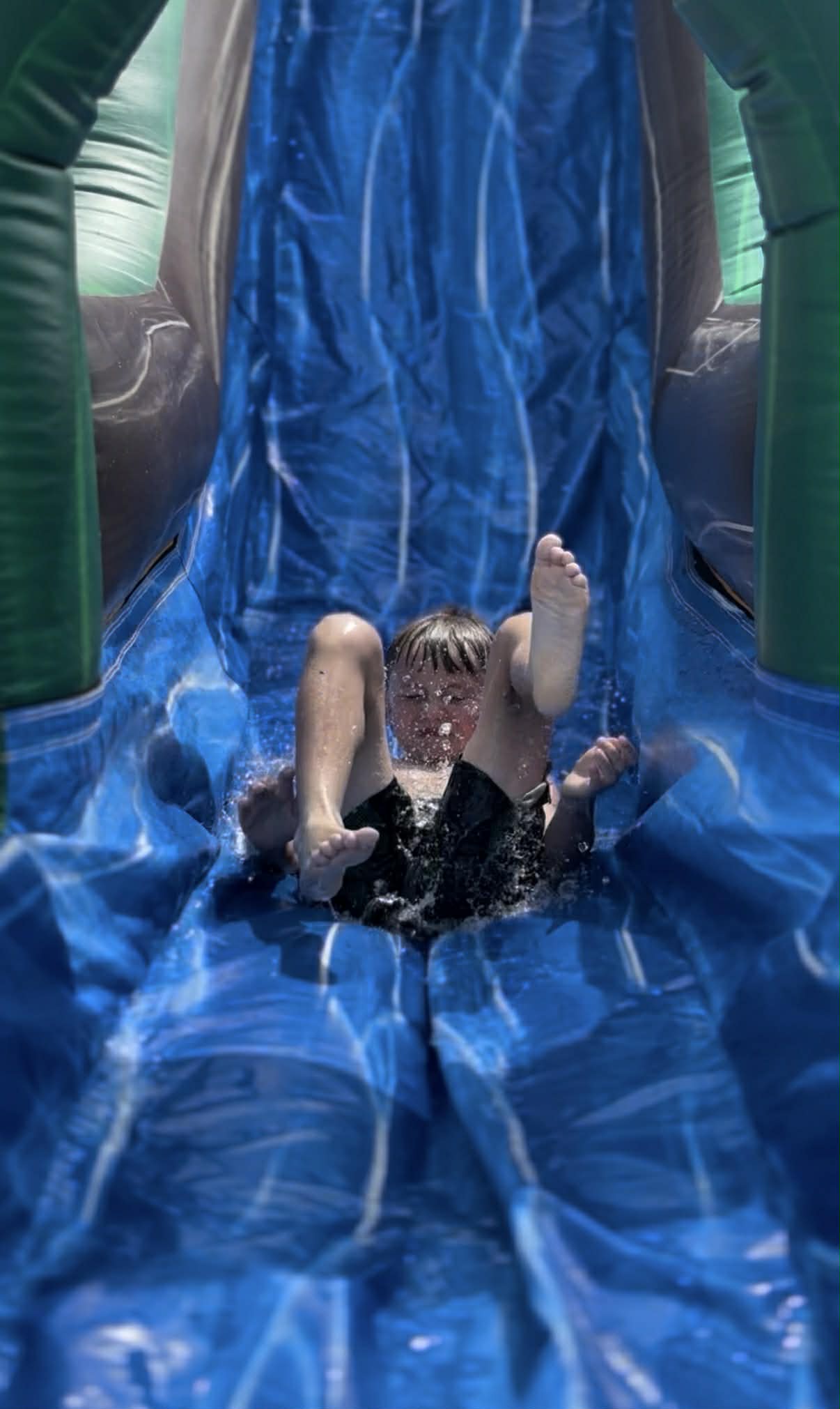 Kids on the 20' Fire & Ice Water Slide at a Backyard Party Rentals event
