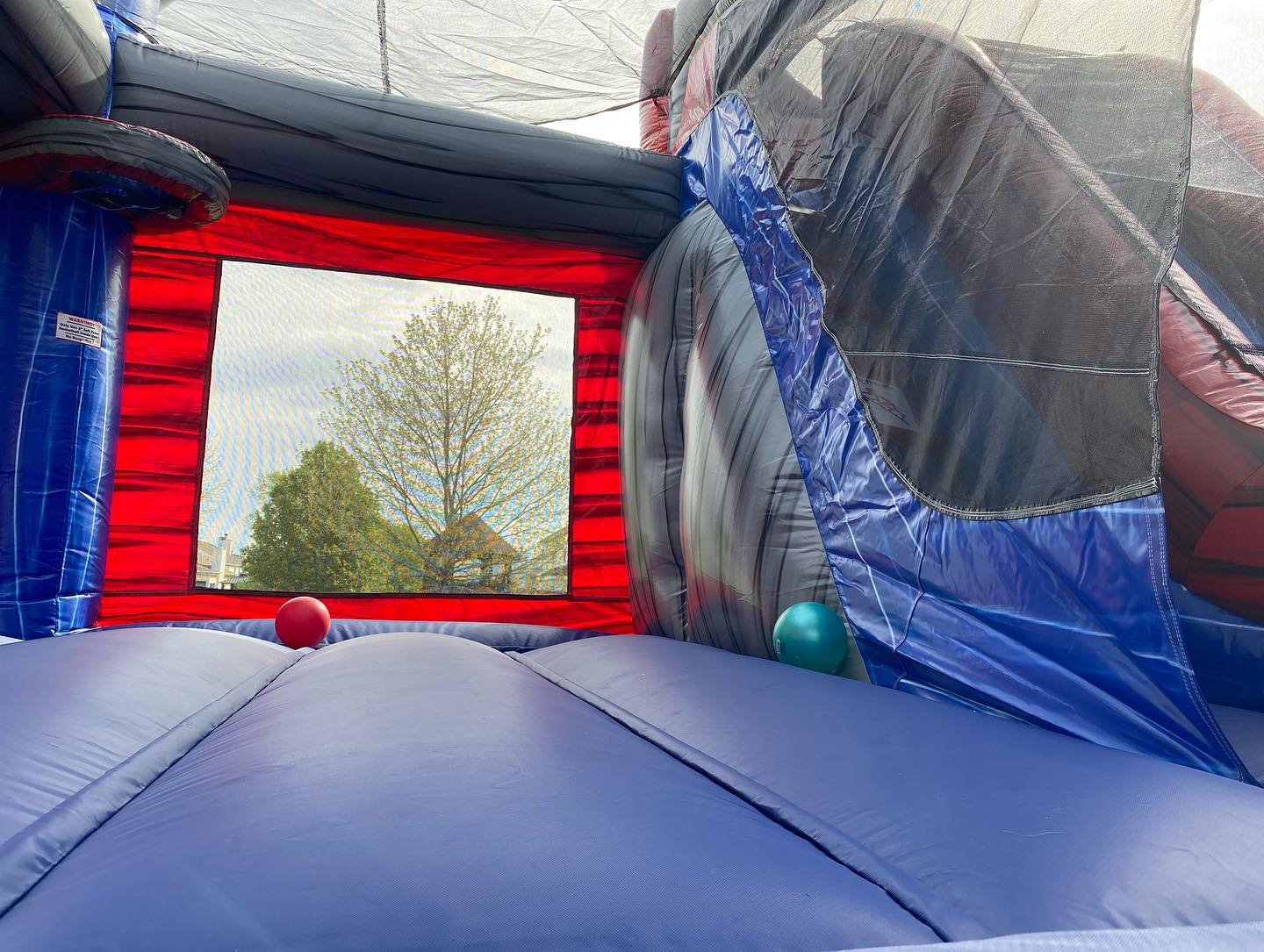 Inside view of the Maui Combo showing the vibrant tropical design and spacious bounce area