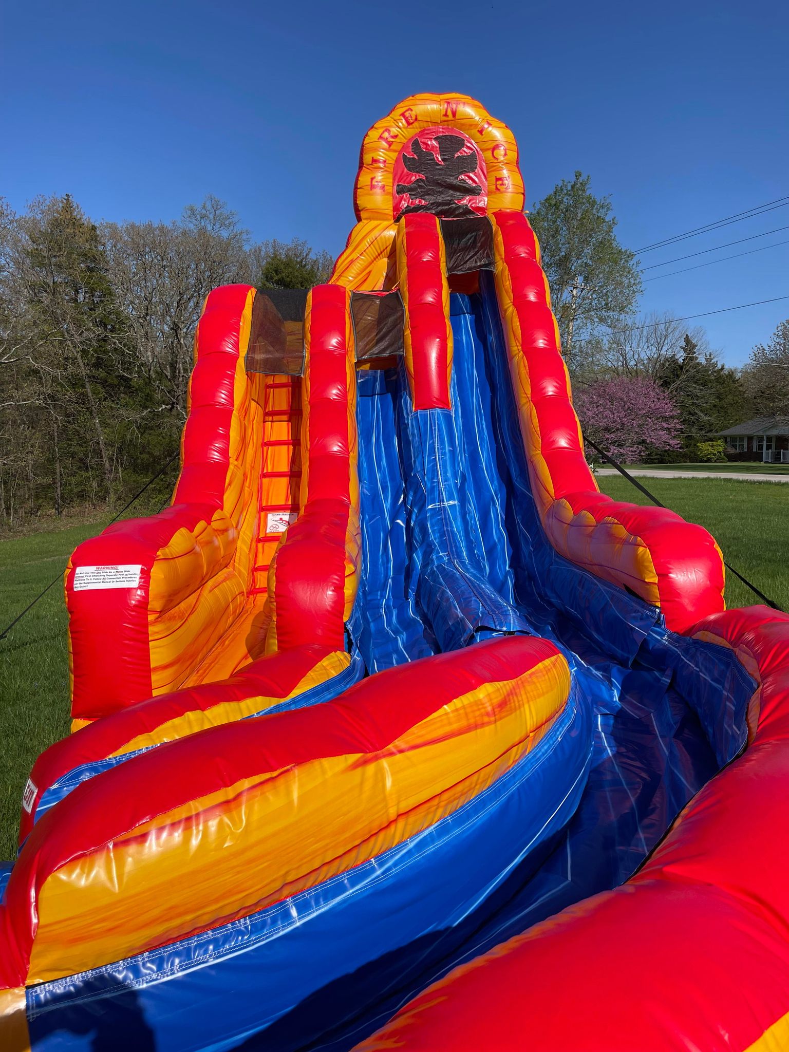 Kids on the 20' Fire & Ice Water Slide at a Backyard Party Rentals event