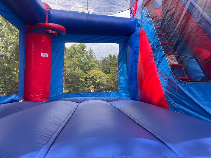 Inside view of the Module Combo showing the spacious bounce area, basketball hoop, and dry slide