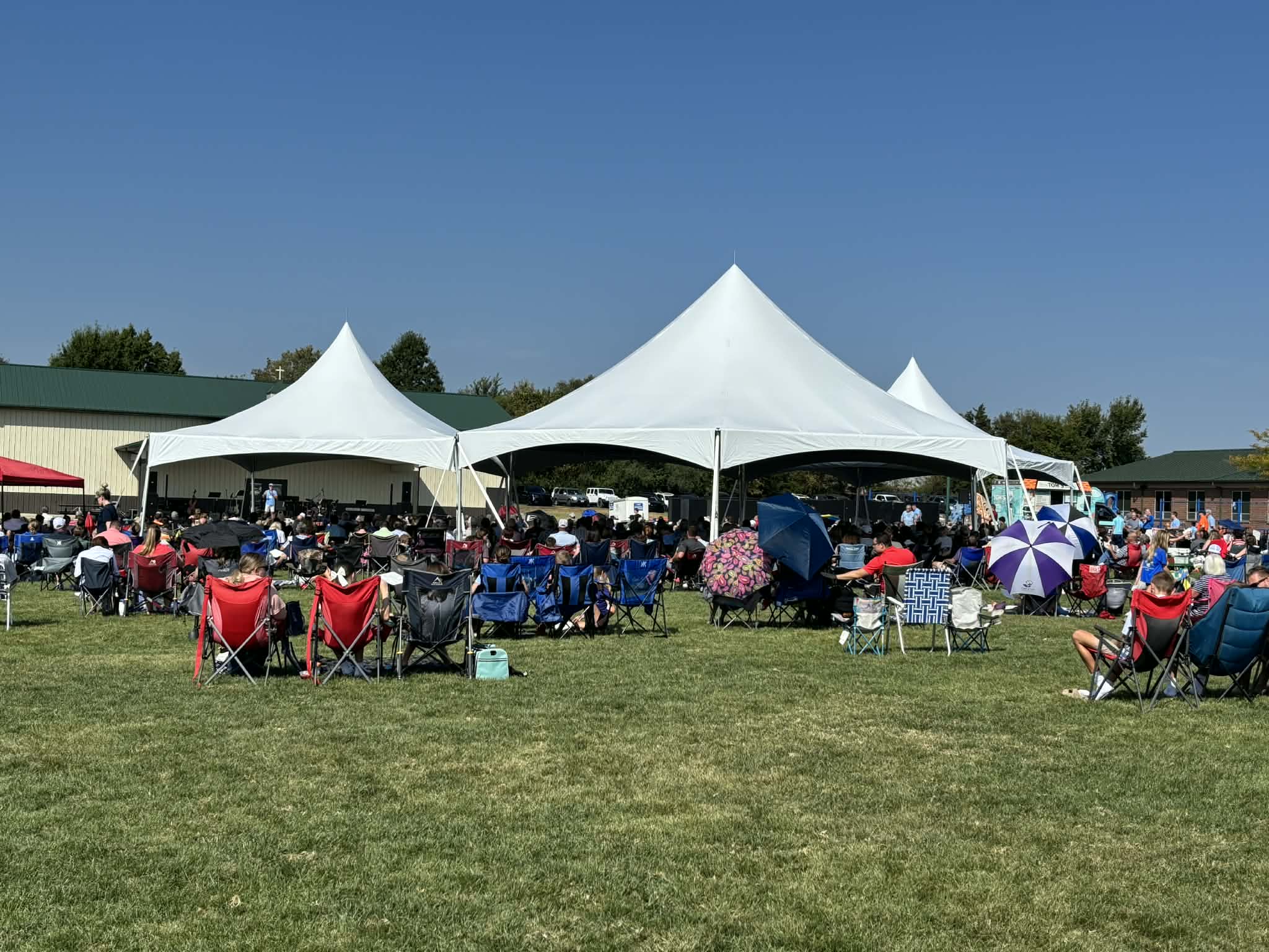 Grand Hex tent setup at a large outdoor event by Backyard Party Rentals in Wentzville MO
