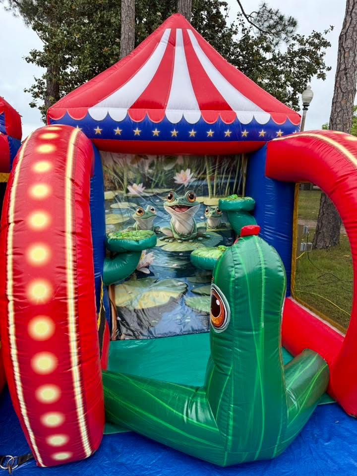 Frog Pond carnival game with red, white and blue carnival tent at a military family day
