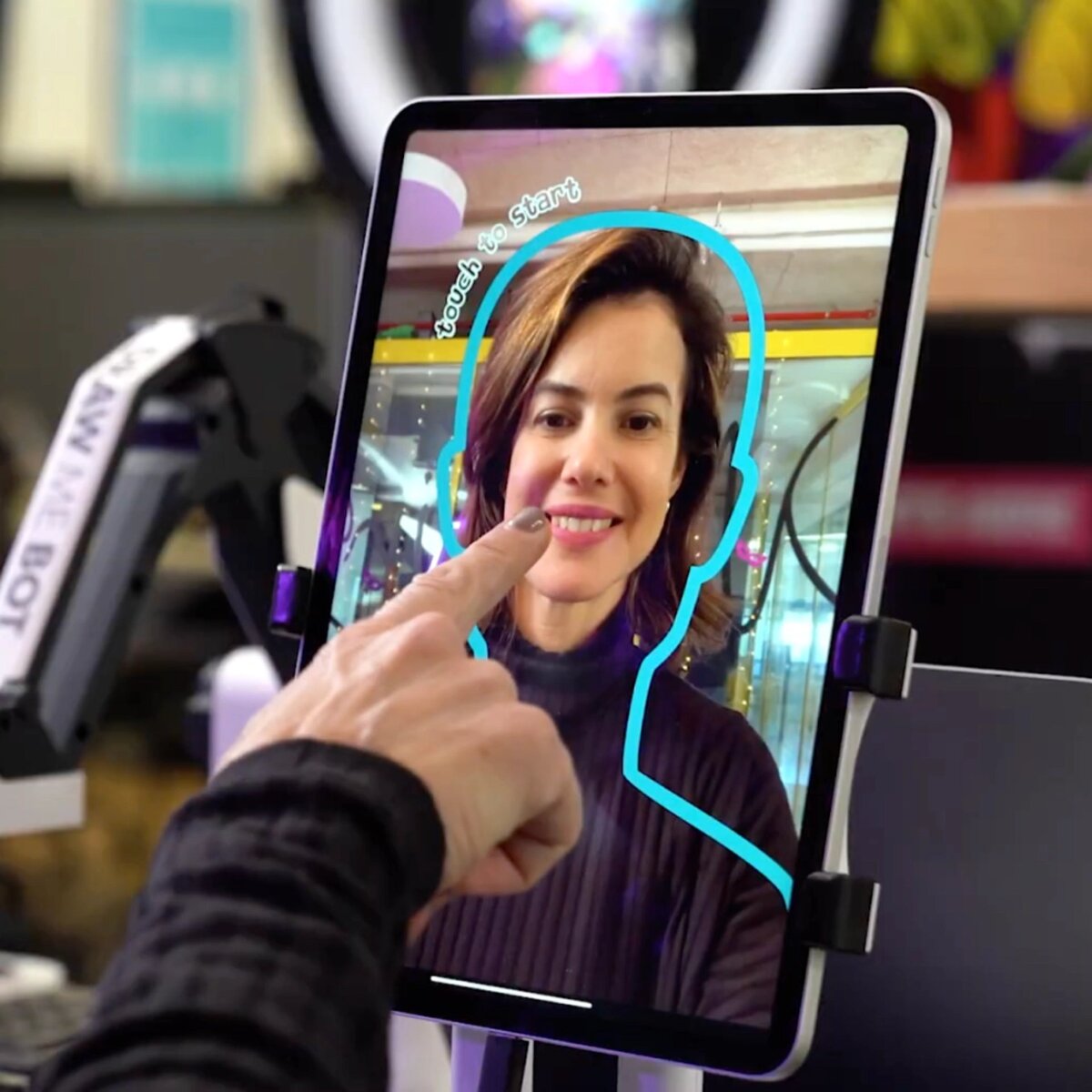 Guest taking a photo at the AI robot caricature tablet station