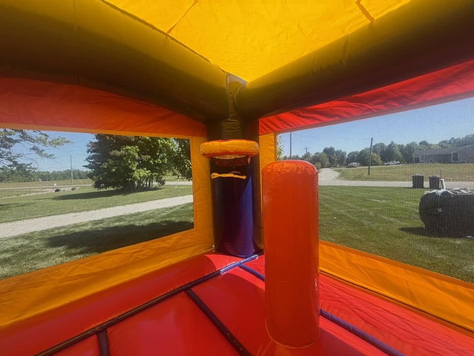 Inside the Classic Castle Combo bounce area with basketball hoop